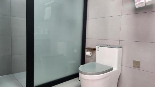 a bathroom with a white toilet in a room at 古北御尚精品民宿Gubeiyushang in Gubeikou