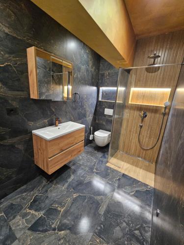 a bathroom with a sink and a toilet at Villa AS MOON with pool in Split