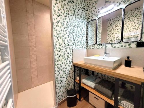 a bathroom with a sink and a shower at Gîte Val Souvigne in Saint-Sylvain