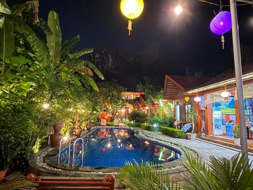 a swimming pool in a yard at night at Tam Coc Friendly Homestay in Ninh Binh