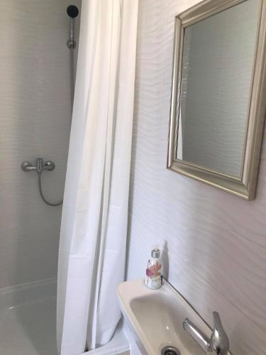 a bathroom with a sink and a mirror and a tub at BorászPorta - Présház in Villány