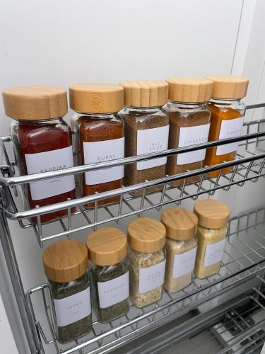 a shelf in a refrigerator filled with jars of food at Abode Africa in Bloubergstrand