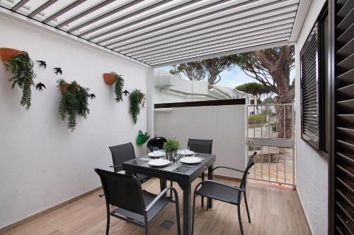 a dining room with a table and chairs at Pear Tree Villa in Vale do Lobo