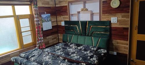 a room with a bed in a room with wooden walls at Global Albaik Holidays in Srinagar