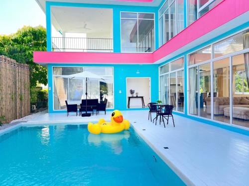 a swimming pool with a rubber duck in the middle of a house at Dream pool villa 3 in Bang Sare
