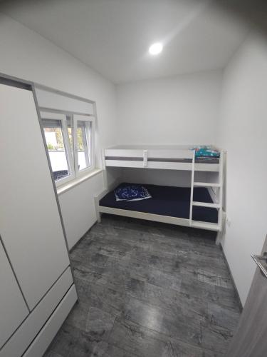 a white room with a bunk bed in it at Villa AS MOON with pool in Split