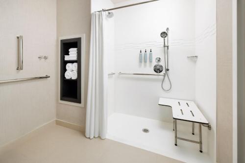 a bathroom with a shower with a bench in it at Residence Inn by Marriott King of Prussia in King of Prussia