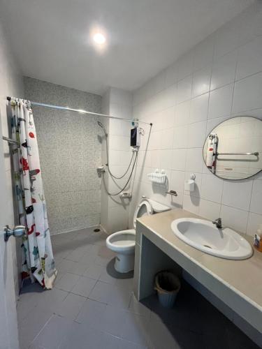 a bathroom with a shower and a toilet and a sink at 84 Bar & Guest House in Ban Huai Luk (1)