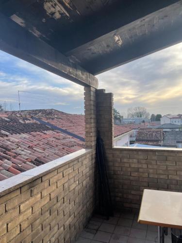 a brick wall with a view of a roof at Rooftop open space in Stra