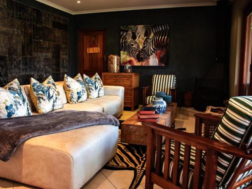a living room with a couch and a table at Cwebile Guesthouse in Winterton
