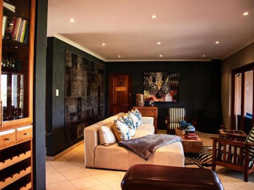 a living room with a couch and a table at Cwebile Guesthouse in Winterton