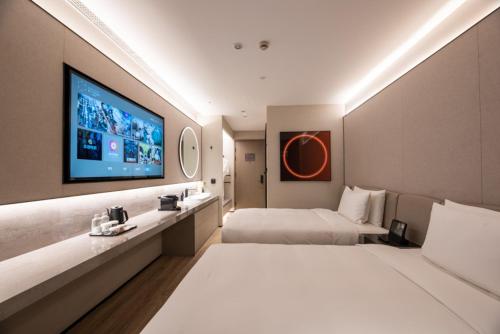 Ένα ή περισσότερα κρεβάτια σε δωμάτιο στο Orange crystal Shanghai Lujiazui Expo Center