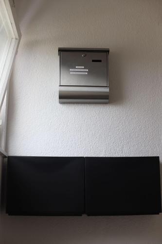 a television on the wall of a room at 1 Zi DG-Apartment in Bad Friedrichshall-Jagstfeld in Bad Friedrichshall