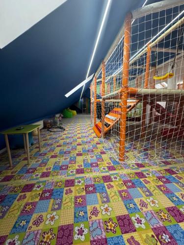 a room with a colorful tiled floor at Guest House Zatyshnyi Dvir in Bukovel