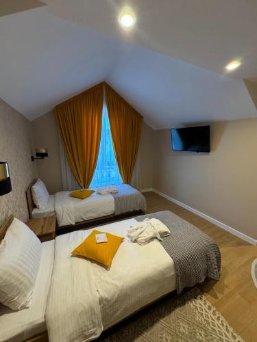 a hotel room with two beds and a window at Guest House Zatyshnyi Dvir in Bukovel