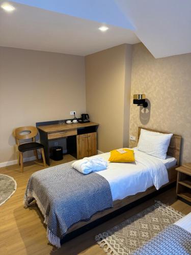 a bedroom with a bed and a desk at Guest House Zatyshnyi Dvir in Bukovel