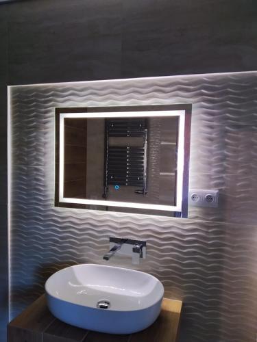 a bathroom with a sink and a mirror at Domek Natalia in Giżycko