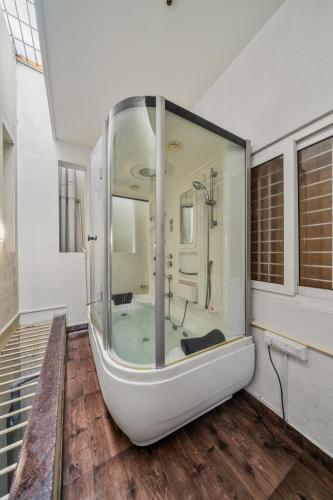 a large bathroom with a tub in a room at Susan Grand penthouse in Bangalore