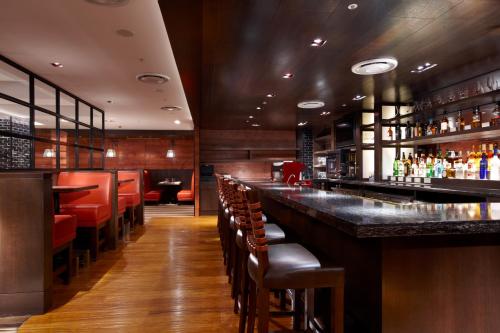 a bar with red seats in a restaurant at Ambassador Hotel Hsinchu in Hsinchu City