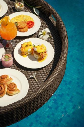 a table with plates of food on top of a table at Fairfield by Marriott Goa Anjuna in Anjuna