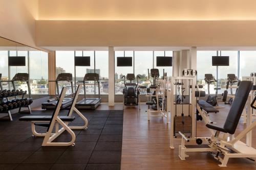 a gym with a lot of treadmills and machines at Dusit Princess Melaka in Melaka