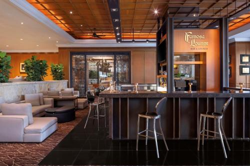 a bar in a hotel lobby with stools at Dusit Princess Melaka in Melaka