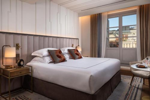 a hotel room with a large bed and a window at Gran Hotel Inglés - The Leading Hotels of the World in Madrid
