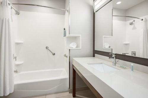 a bathroom with a sink and a tub and a shower at Courtyard by Marriott Auburn in Auburn