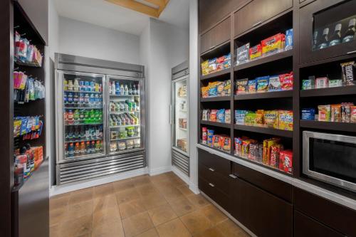 a grocery store aisle with two refrigerators at Courtyard by Marriott Auburn in Auburn
