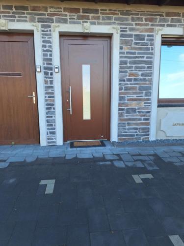 two brown doors on a brick building at Villa Rustica in Xanten