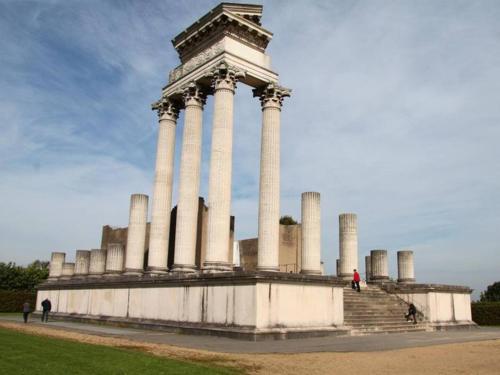 a large building with columns with people walking around it at Villa Rustica in Xanten