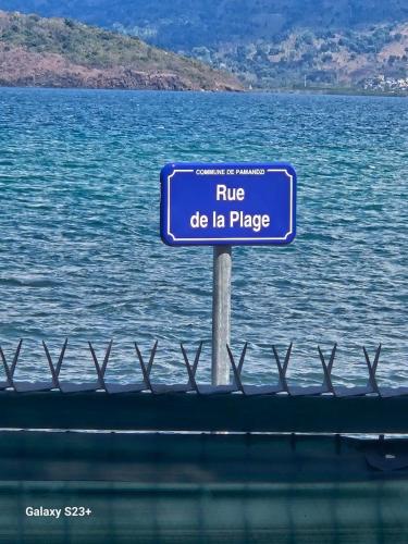 a blue sign that readsrue do la place at LA KAZ by KAZ KAFE in Pamandzi