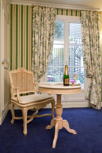 a room with a table and a chair and a window at Hôtel Beaubourg in Paris