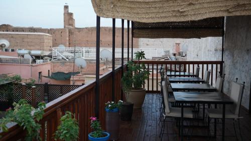 a balcony with tables and potted plants on a building at RIAD KALE POLIS in Marrakech