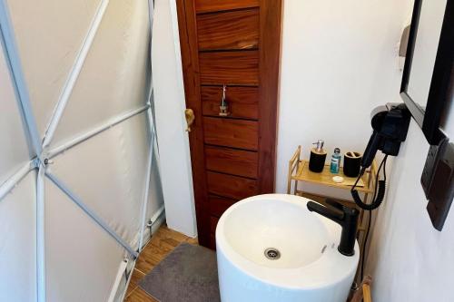 a bathroom with a toilet and a sink at Txaleta de Camiguin desde 2024 in Mambajao