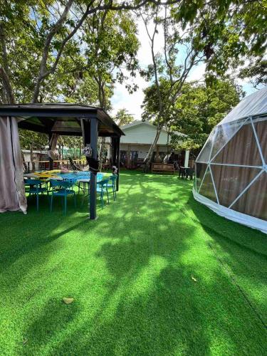 a gazebo with a picnic table and a tent at Txaleta de Camiguin desde 2024 in Mambajao
