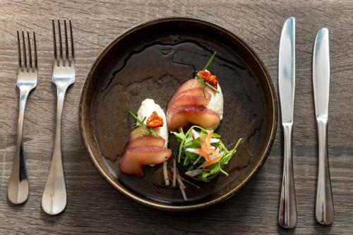 a plate of food on a table with forks and knives at The Lansdowne, Eastbourne in Eastbourne
