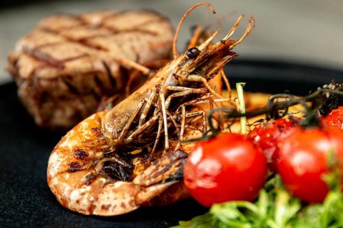 a close up of some food with tomatoes and bread at The Lansdowne, Eastbourne in Eastbourne