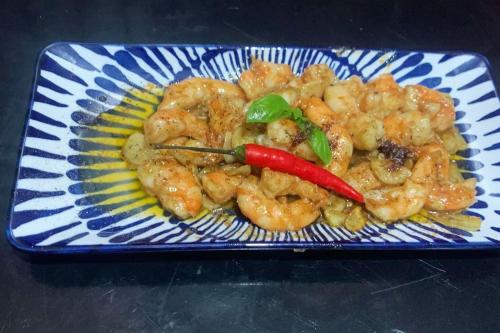 a blue and white plate of food with shrimp at Txaleta de Camiguin desde 2024 in Mambajao