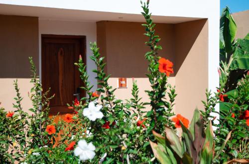 a house with flowers in front of a door at Oasis Blu Beach Resort-Adults Only in Nungwi