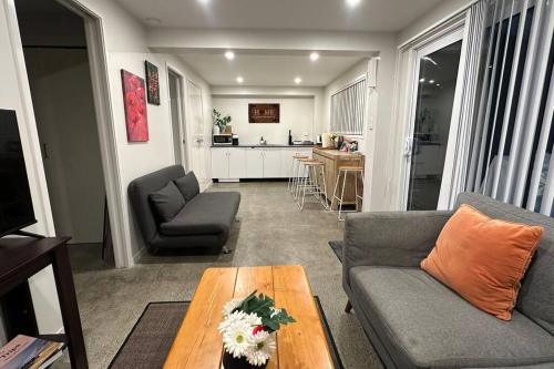 a living room with a couch and a table at Cozy 1 Bed 1 Bath Studio Kingsland - Morningside in Auckland