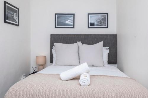 a bedroom with a bed with two towels on it at The Willets Boutique Hotel in Simon's Town in Simonʼs Town