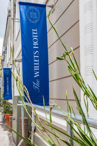 a banner on the side of a house with plants at The Willets Boutique Hotel in Simon's Town in Simonʼs Town