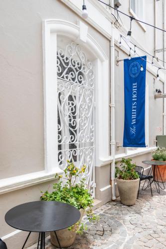 a gate on the side of a building with a table at The Willets Boutique Hotel in Simon's Town in Simonʼs Town