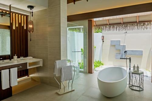 a bathroom with a large tub and a shower at Pullman Maldives Maamutaa - All-Inclusive Resort - 50 percent off Transfers in Maamutaa