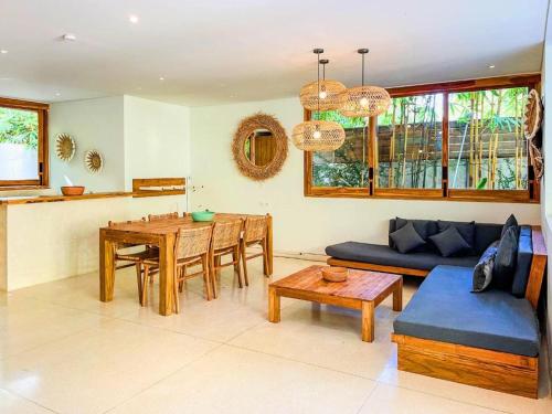 a living room with a couch and a table at Marlaca Villas Lombok in Kuta Lombok