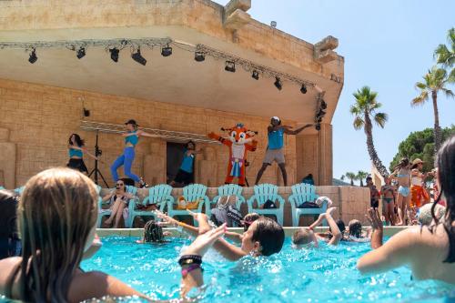 a group of people in the water watching a performance at Camping les Cigales in Le Muy