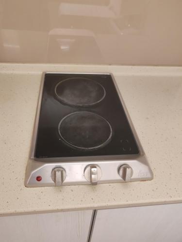 a stove top oven sitting on top of a counter at No Other Fee #Swiss Garden Residences by The Boston House #Bukit Bintang in Kuala Lumpur