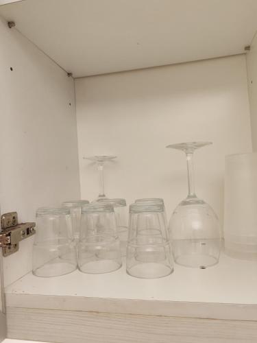 a row of glasses sitting on a shelf at No Other Fee #Swiss Garden Residences by The Boston House #Bukit Bintang in Kuala Lumpur