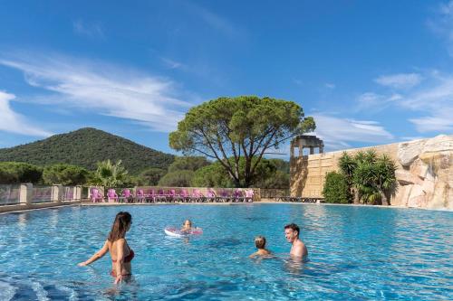 a group of people in the water at a swimming pool at Camping les Cigales in Le Muy